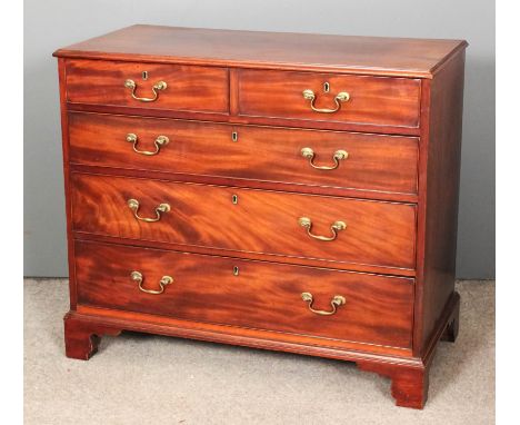 A George III figured mahogany chest of drawers, the top with moulded edge, fitted two short and three long drawers, on bracke