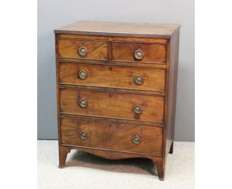 A mahogany chest of drawers of Georgian design and of small proportions, the top with reeded edge, fitted two short and three