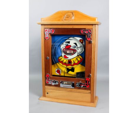 A 1950s Bryan's oak cased penny-in-the-slot "Pilwin" Alwin game with clown's face to back panel, in modern replica oak case, 