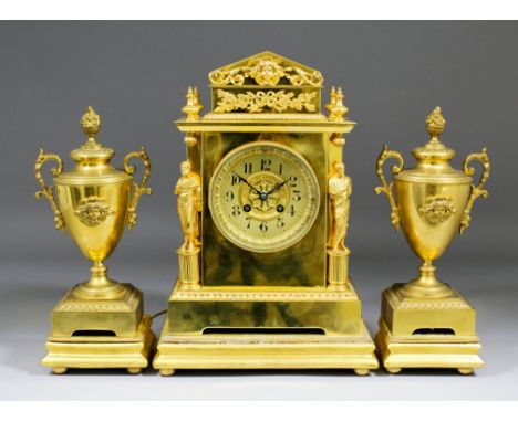 A late 19th/early 20th Century French gilt brass three piece clock garniture, the clock with 3.75ins diameter gilt dial with 