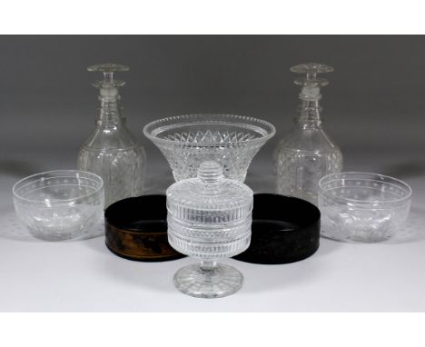 A pair of English Regency glass decanters and stoppers with hobnail and panel cutting and three rings to the neck, each 9ins 