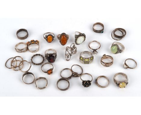 Twenty seven silver rings of varying sizes, including an synthetic opal and marcasite ring, ring size P, an open work scroll 