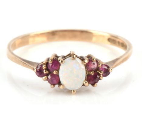Opal and Ruby ring with tapered shoulders, hallmarked London 1987 9 ct yellow gold, ring size N Condition Report:  9 ct gross