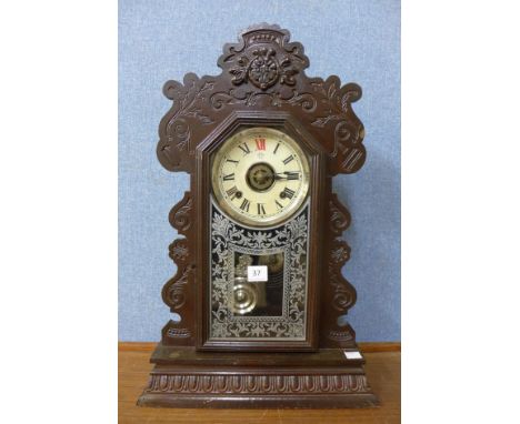 A late 19th Century American Kerimore gingerbread shelf clock, with eight day spring driven movement