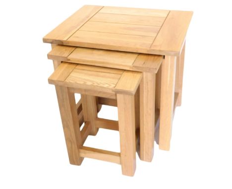 A nest of three light oak tables, of plain form, 50cm wide. 