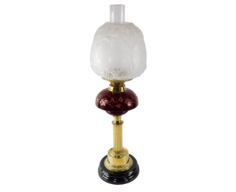 A Victorian style oil lamp, with frosted shade and ruby tinted cut glass reservoir, on a brass base, 35cm high overall. 