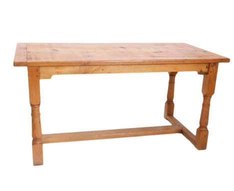 A light oak refectory table, the planked top with cleted ends, on part turned supports with flat H stretcher, 76cm high, 153c