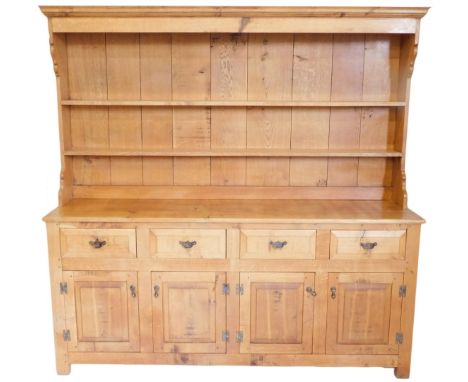 A light oak dresser, in late 18thC style, the plate rack with a moulded cornice and two shelves, the base with an arrangement