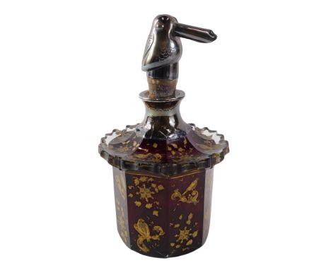 A Bohemian ruby glass scent bottle, with gilt decoration of leaves and flowers, white metal collar, and bird shaped stopper, 