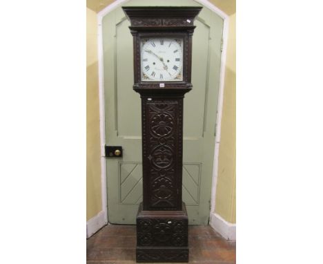 An early 19th century longcase ting tang clock, carved throughout with repeating geometric and other detail, the square cut h