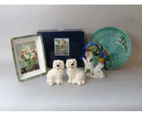 A pair of Royal Doulton spaniels in the Staffordshire manner, a Capodimonte model of a pair of parrots, a Schremberg majolica