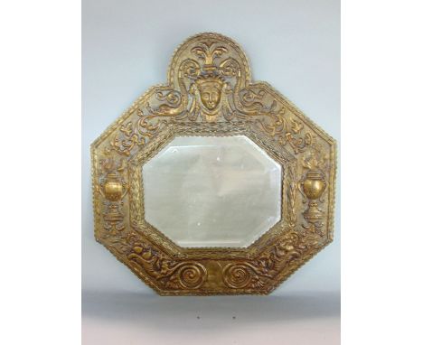 18th century embossed brass wall mirror of octagonal form, the framework with a repeating geometric urn, scroll and mask deta