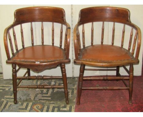 Three similar Edwardian office desk chairs, with bowed turned spindle backs over rexine upholstered  pad seats, raised on par