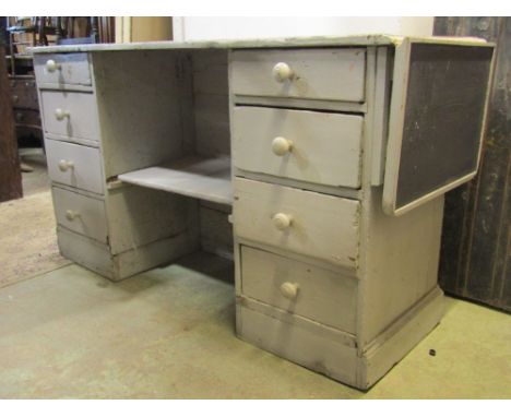 A Victorian pine shop counter with later painted finish, the rectangular top with single drop leaf and panelled front, the re