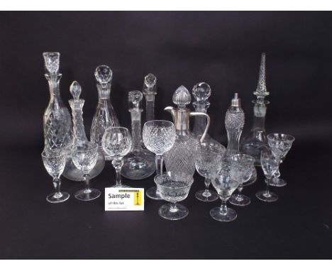 A collection of decanters and stoppers of various form with cut and faceted detail, together with a claret jug with plated mo