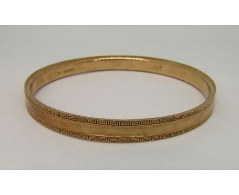 9ct bangle with Greek key decoration, with pouch, 13.8g