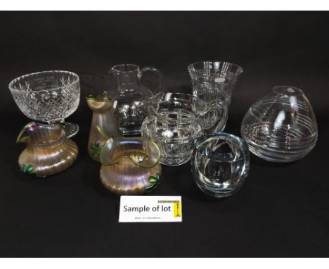 A collection of glassware including a garniture of three early 20th century art glass vases with green iridescent overlaid de