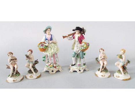 A pair of continental figures of male and female gardeners with flower baskets, 24cm tall approx, together with a set of four