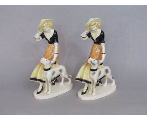 A pair of German ceramic figure groups in the art deco manner, of women with dogs, with printed and impressed marks to base, 