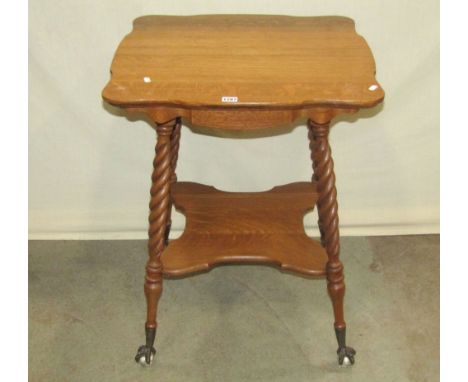 A late 19th century medium to light oak two tier occasional table with shaped and moulded outline, raised on four splayed rop