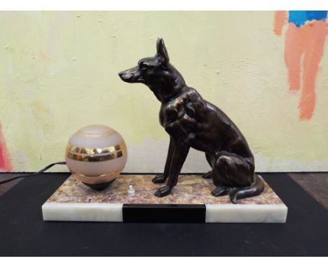 Art Deco figural lamp in the form of an Alsatian next to a pink shade with gilt highlights, upon a marble base, 38cm long
