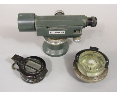 A surveyors level by Watts, a worldwide II military compass - TG &amp; Co Ltd number B221382, 1943 mark III and one other