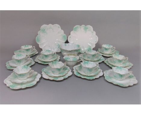A collection of Foley china teawares with green printed daisy detail comprising milk jug, slop bowl, pair of cake plates, ten