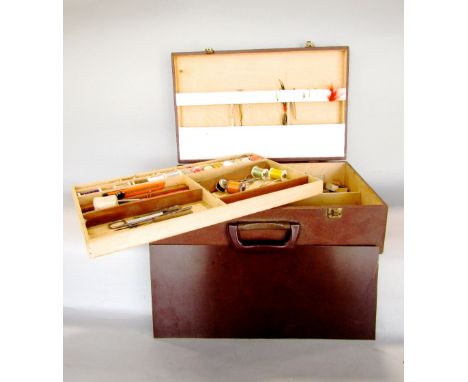 A travelling case containing a collection of fly fishing effects, ties, hand tools, etc