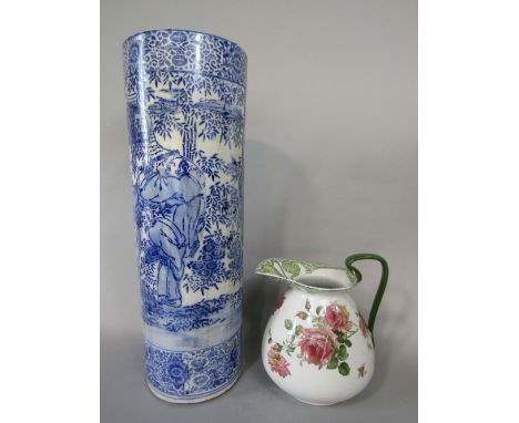 A late 19th century oriental blue and white vase/stickstand of cylindrical form, blue and white painted decoration of male ch