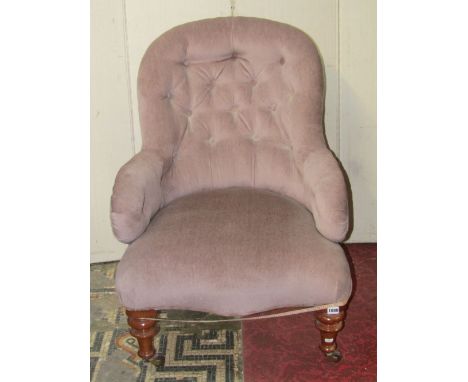 A Victorian spoonback drawing-room chair with upholstered finish, raised on turned, tapered forelegs with brown ceramic casto