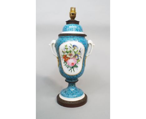 A 19th century two handled lamp base in the form of a vase and cover, with painted floral panels on a blue ground with simula