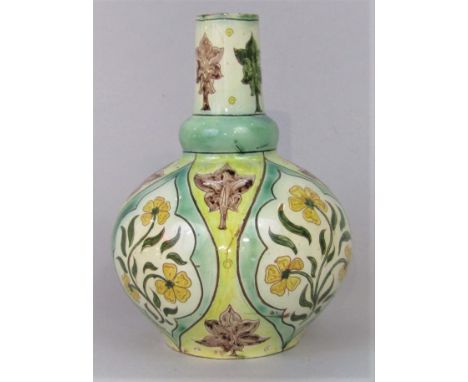 A Della Robbia pottery vase with bulbous body and drawn neck and painted stylised floral decoration, and it has incised boat 