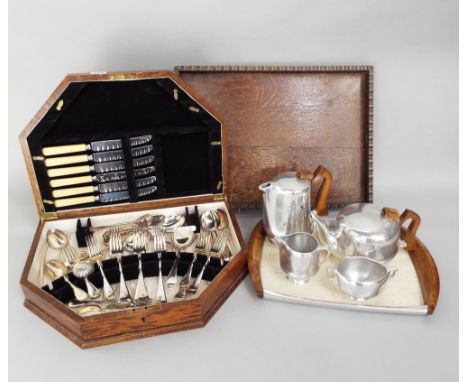 An oak canteen containing a quantity of plated flatware, together with a four piece Picquot ware tea service and matching tra