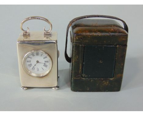 Early 20th century silver cased carriage type timepiece, the enamel dial with Roman numerals, the case with scrolled hinged h
