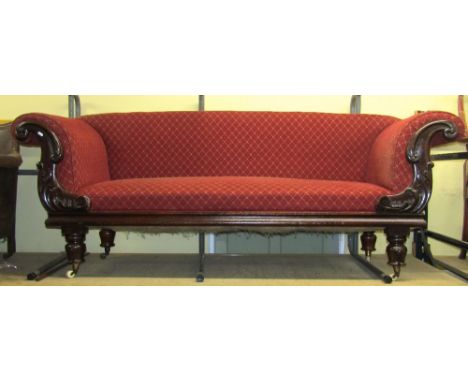 A late Regency/William IV mahogany scroll end sofa with carved and applied detail raised on carved supports, 220 cm wide