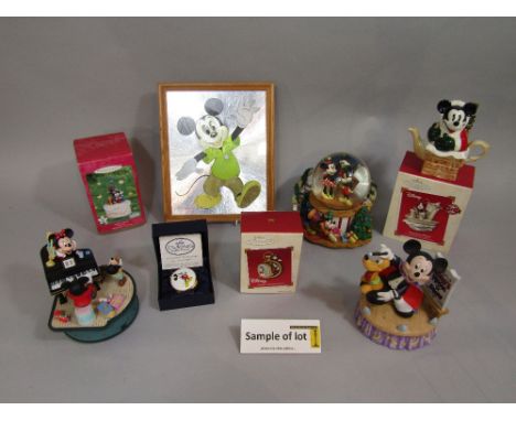 A quantity of Disney related items including a musical snow globe, further musical groups, Christmas tree decorations, frames