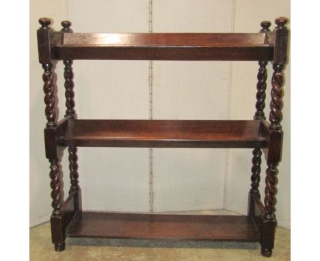 A 1920s oak three tier book stand raised on barley twist supports together with small walnut veneered freestanding display ca