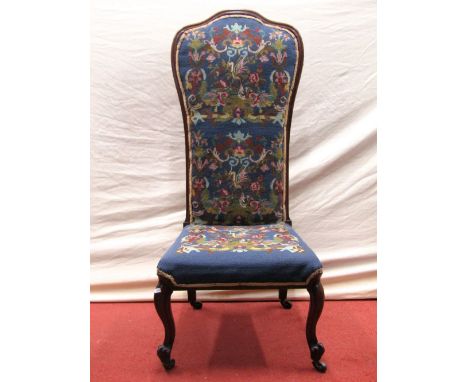 A Victorian rosewood nursing chair raised on cabriole supports with later hand worked tapestry seat and back and a Jacobean r