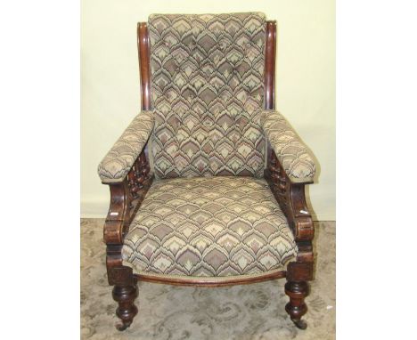 A Victorian drawing room chair with later stylised upholstered seat, button back and arms, raised on turned rails and support