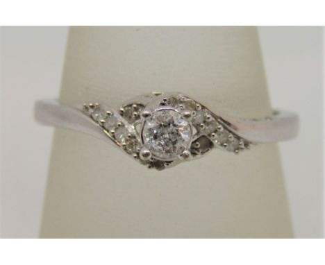 9ct white gold diamond crossover style ring, centre stone 0.20cts approx, size R, 2.4g 