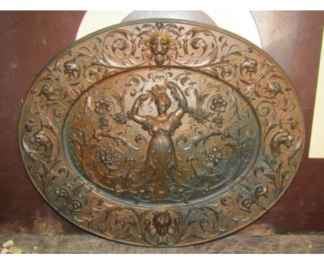 Art Nouveau bronzed cast iron plaque embossed with a maiden with her hands in the air, with floral swags  and scrolled acanth