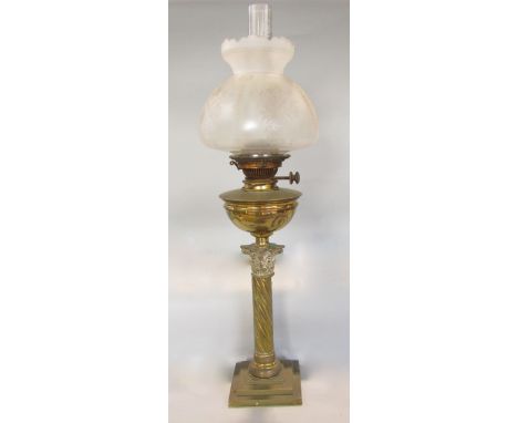 A Victorian brass table standing oil lamp with wrythen fluted column on a square cut base with single burner and etched glass