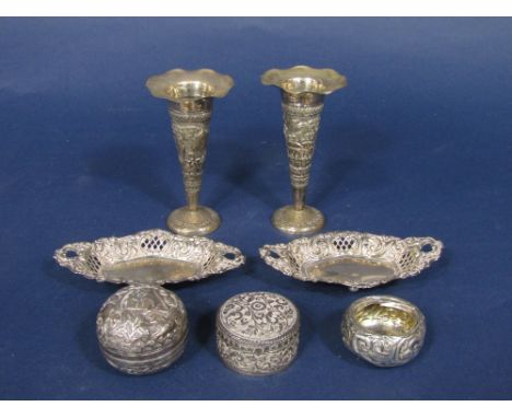 A pair of Victorian silver trinket dishes with pierced diaper sides upon ball feet, with a group of eastern white metal items