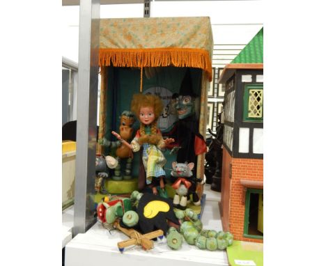 A Pelham Puppets theatre including five puppets (a witch, a baby dragon, a mouse, a cat and a girl) with winch operation and 
