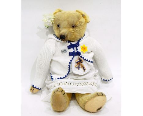 A Merrythought plush bear with glass eyes and button to ear, label to foot 