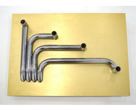 A wall light, the brass-finished mount with four aluminium 'water pipes' protruding, 70 x 50 cm CONDITION REPORT: Re-wiring r