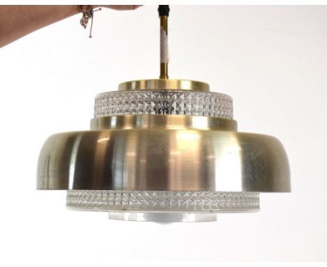 A 1970's ceiling light, the moulded glass brick-type inner shade surrounded by a brass-finished shade CONDITION REPORT: Worki
