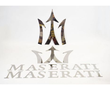 Two sets of stainless steel Maserati signs including the three-part trident logos, h. 95 cm each, and the individual letters
