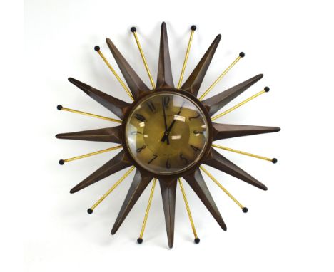 An Anstey &amp; Wilson 'starburst' or 'sunburst' clock, the plain brass face with Arabic numerals surrounded by brass rays an
