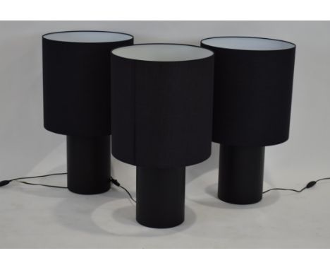 A set of three Casamilano 'Ana' table lamps with black cylindrical bodies and matching shades CONDITION REPORT: Shade on one 